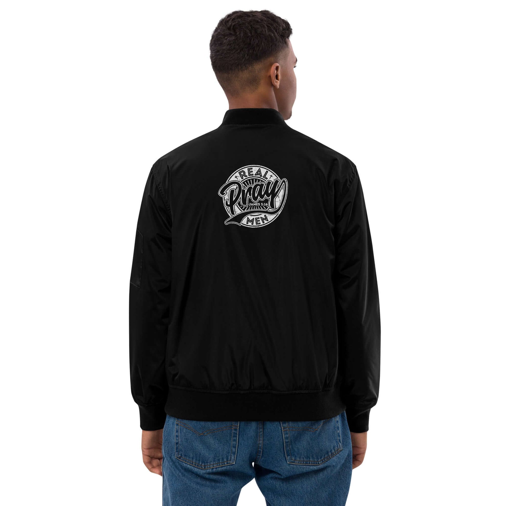 Real Men Pray premium bomber jacket displayed from the back, embracing faith with stylish Christian clothing in the UK.