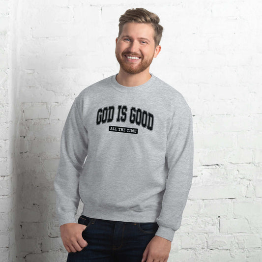 Man wearing a "God is Good" grey sweatshirt, promoting Christian clothing and positivity in the UK.