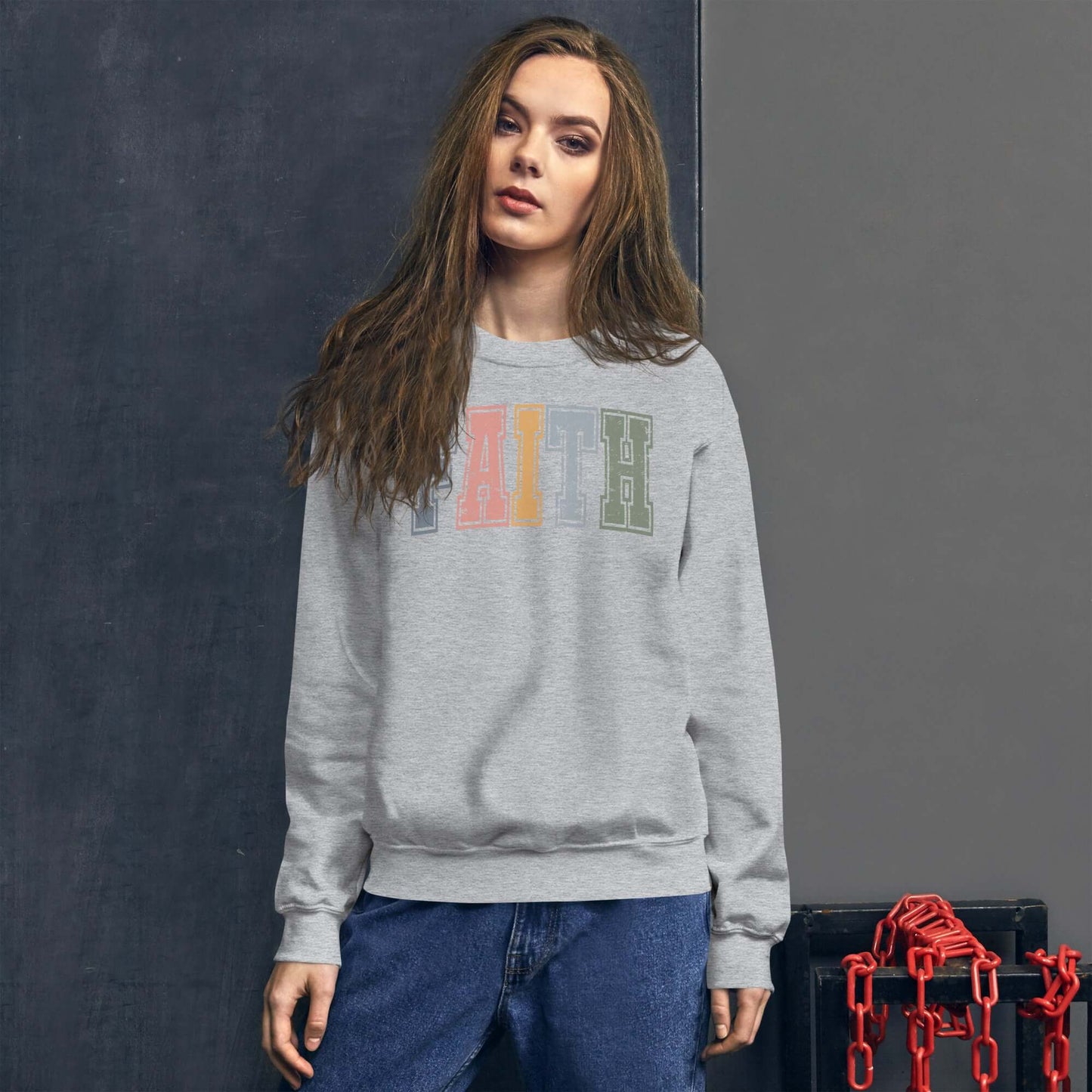 Stylish grey sweatshirt with "Faith" in colorful letters, perfect for Christian clothing enthusiasts in the UK.