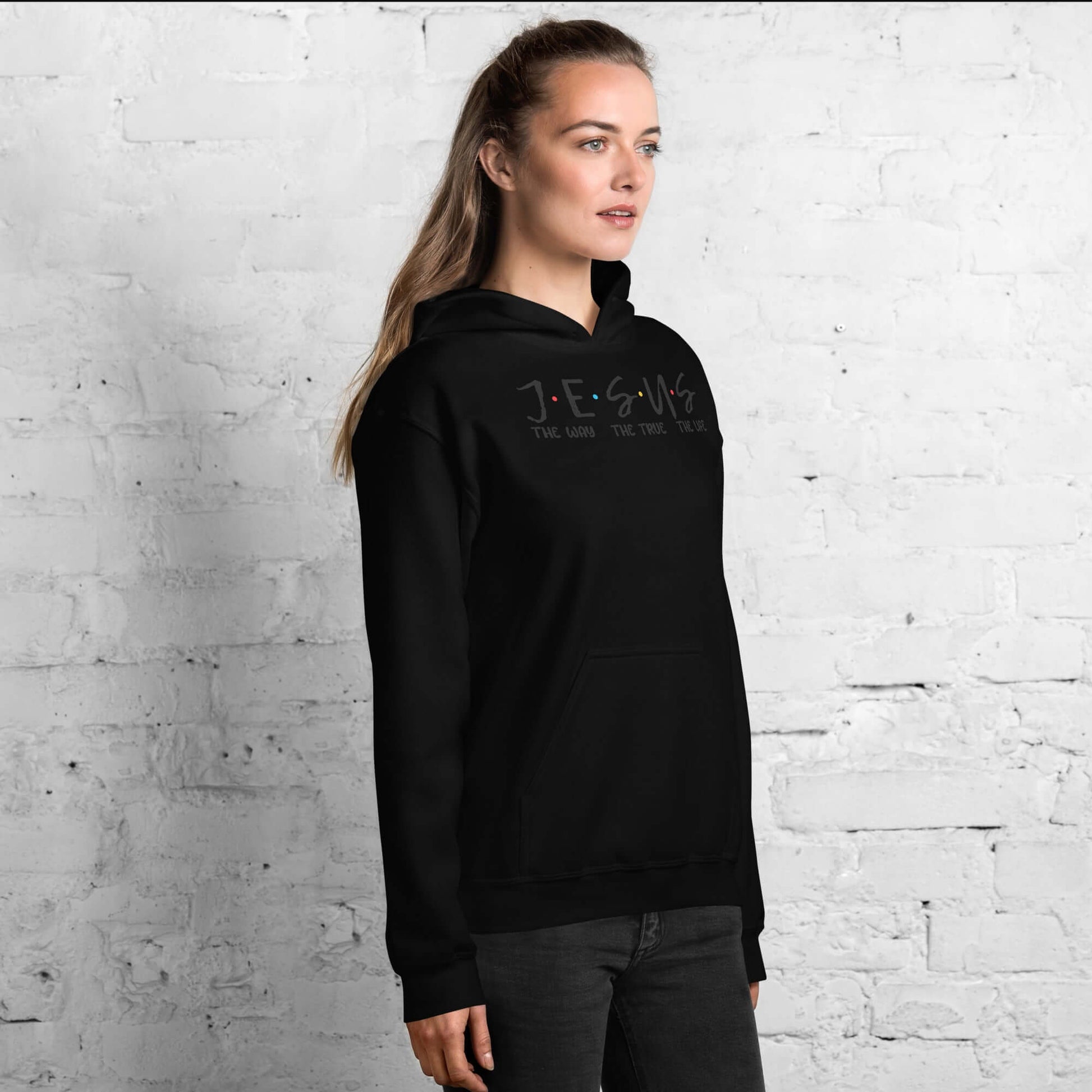 Unisex JESUS Hoodie in black, inspired by Friends sitcom, showcasing bold letters with colorful dots, perfect for Christian clothing UK.