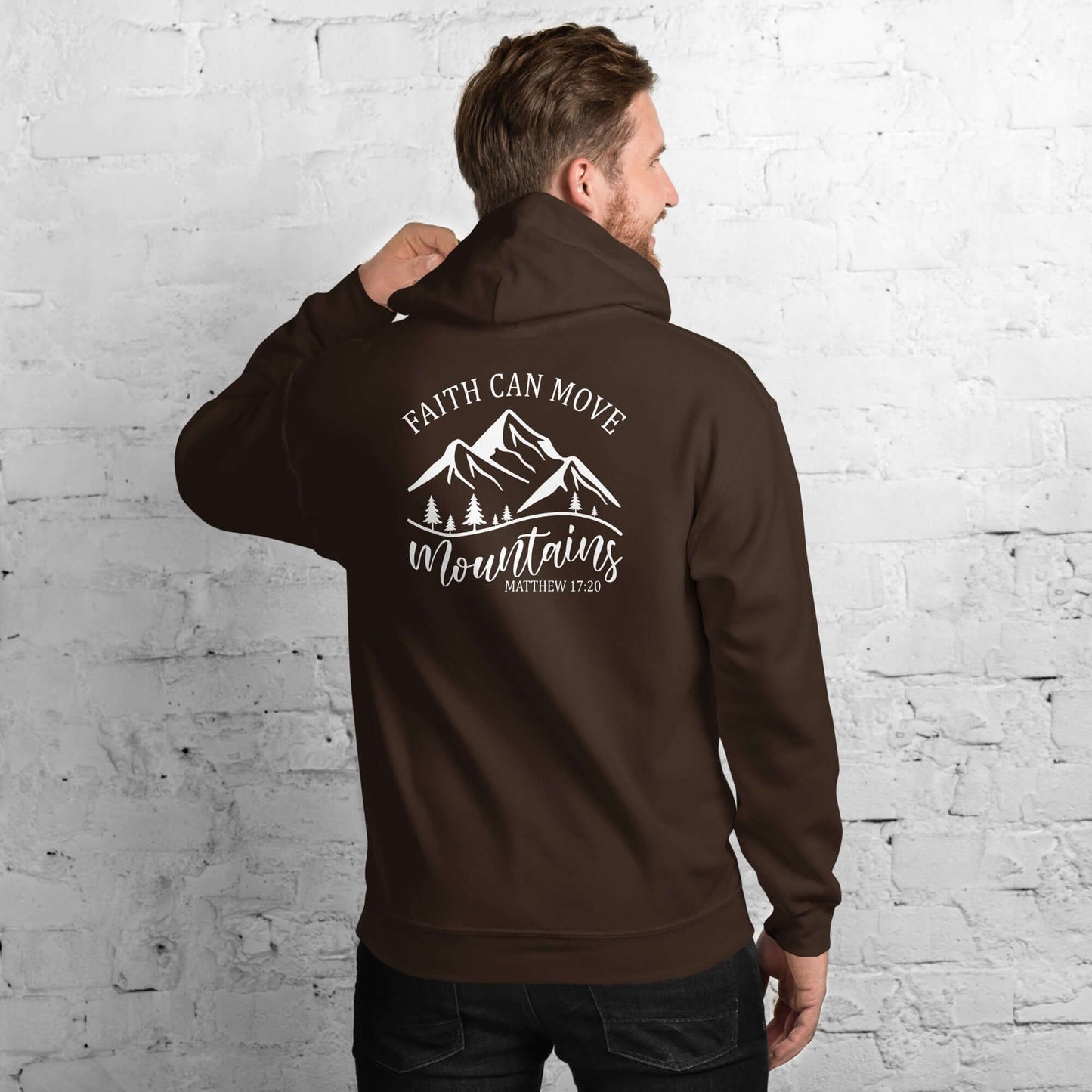 Man wearing brown hoodie with "Faith Can Move Mountains" design, promoting Christian Clothing UK.