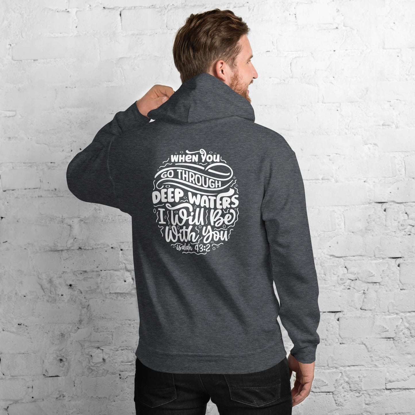 Man wearing 'Through Deep Waters' hoodie inspired by Isaiah 43:2 with faith quote, Christian clothing UK