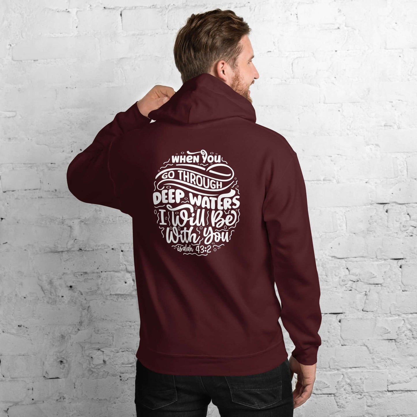 Man wearing a burgundy "Through Deep Waters" hoodie with inspirational Isaiah 43:2 quote, Christian clothing UK.