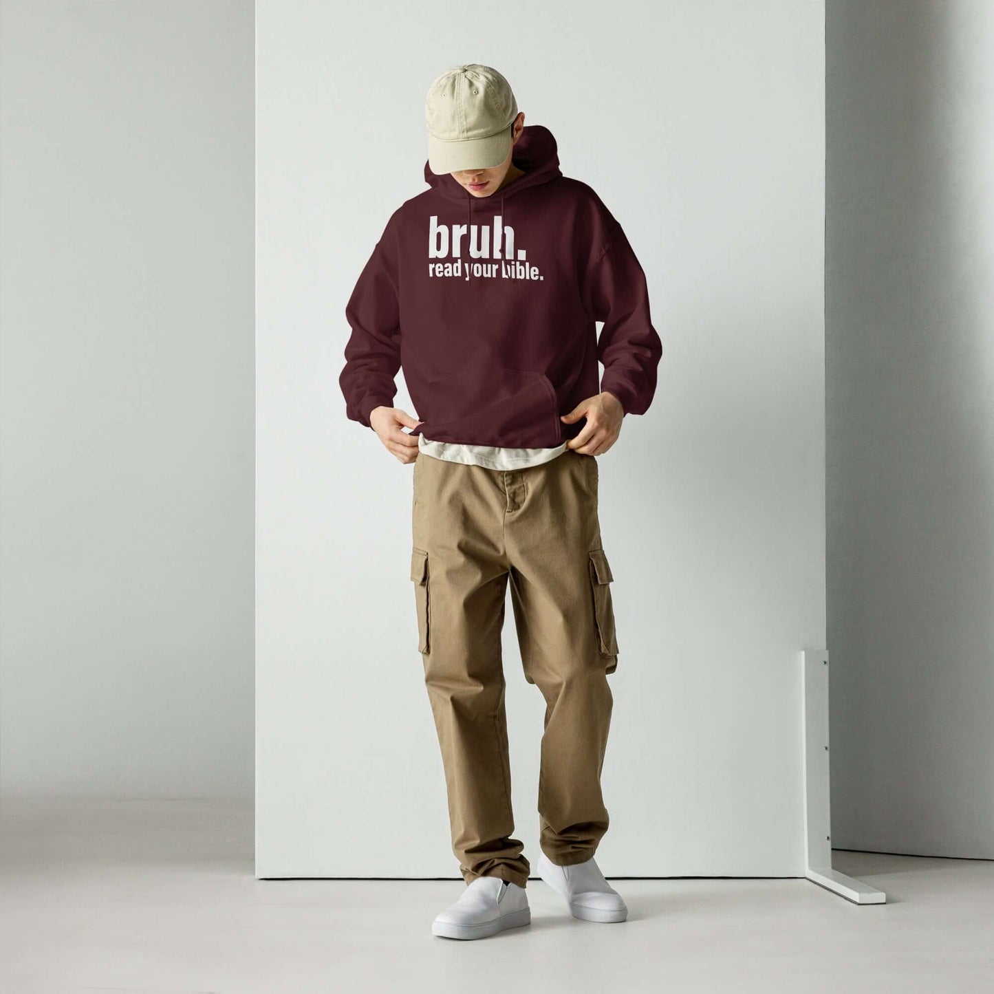 Man wearing a maroon "Bruh, Read Your Bible" hoodie paired with khaki cargo pants, promoting Christian apparel style.