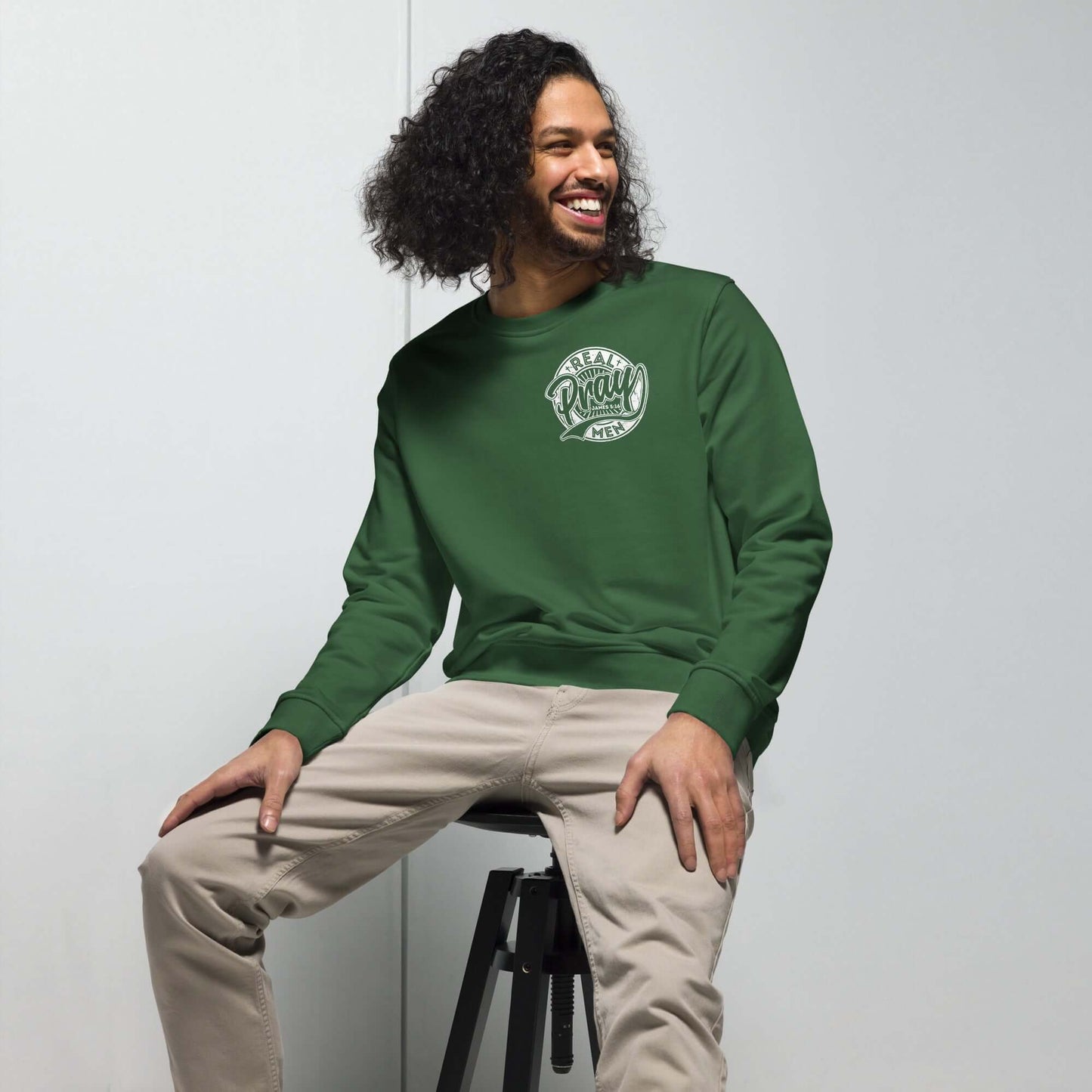 Man wearing green "Real Men Pray" organic sweatshirt, showcasing Christian clothing in the UK.