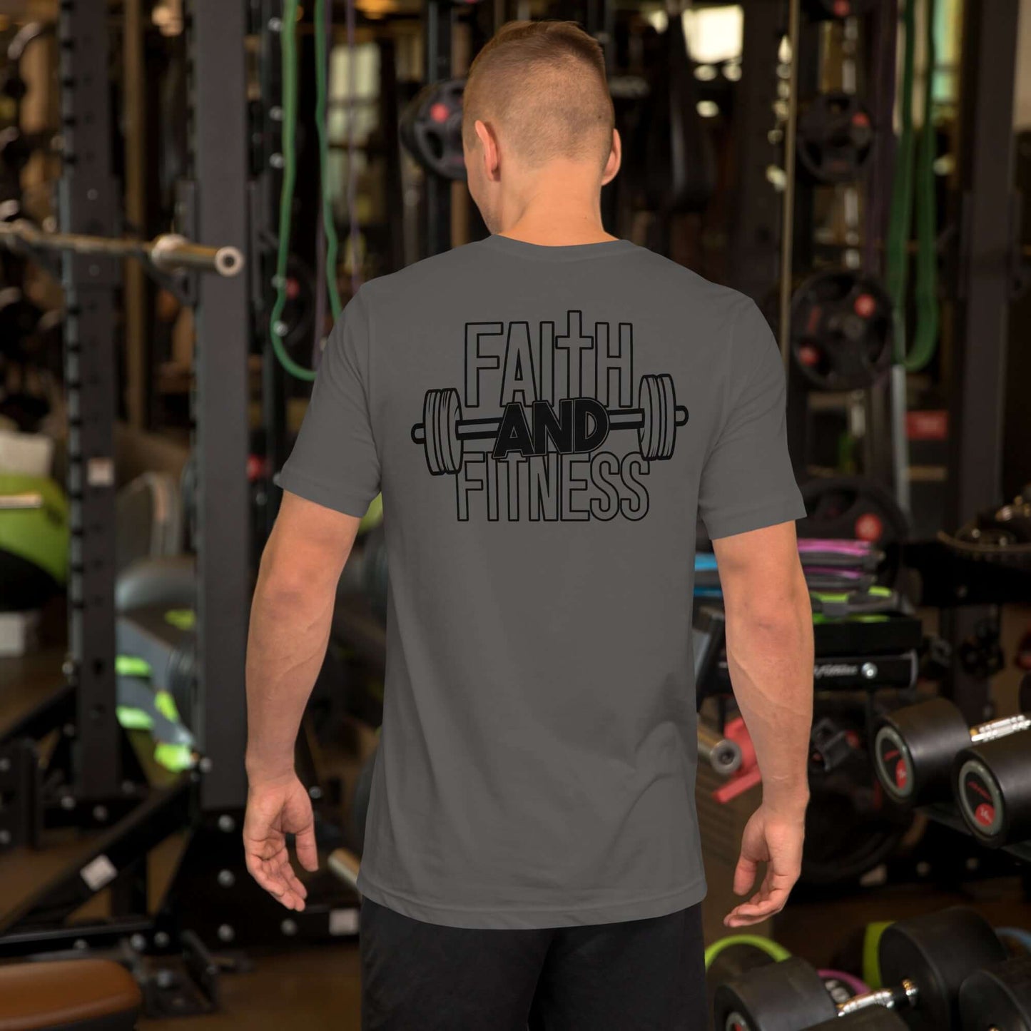 Back view of a man in a gray Faith and Fitness Christian T-shirt in a gym, promoting spiritual strength and fitness.