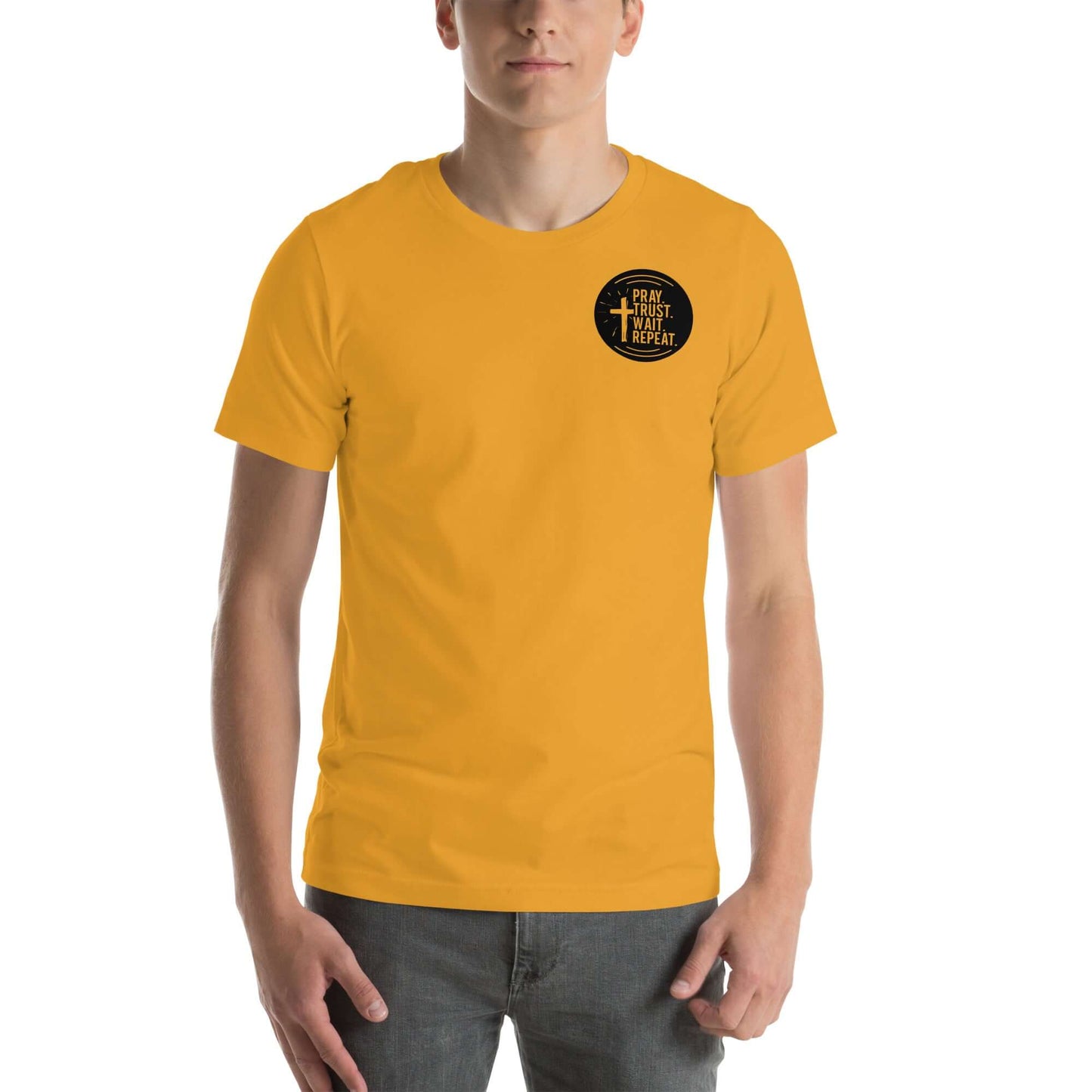 Young man wearing a yellow Christian T-shirt with "Pray. Trust. Wait. Repeat." design, representing faith and perseverance.