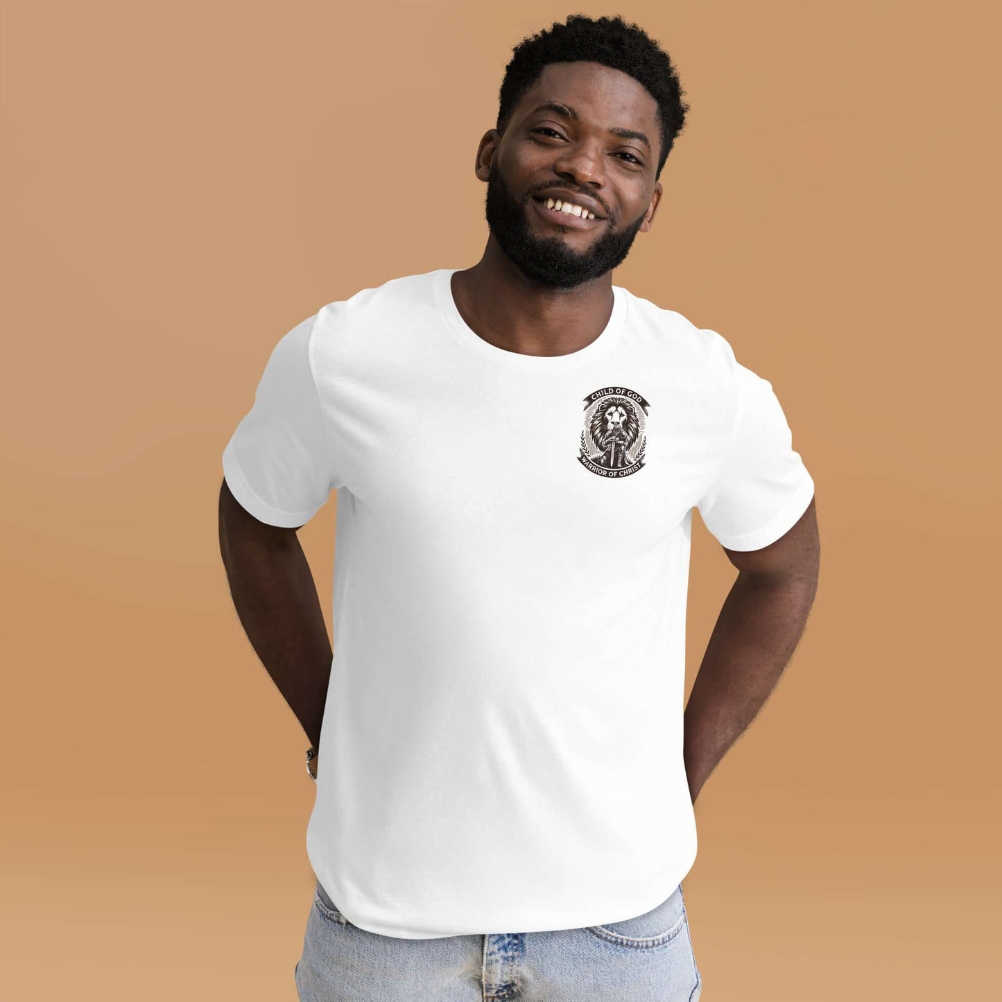 Smiling man wearing a white Christian T-shirt with 'Warrior of Christ' logo, standing confidently against a peach background